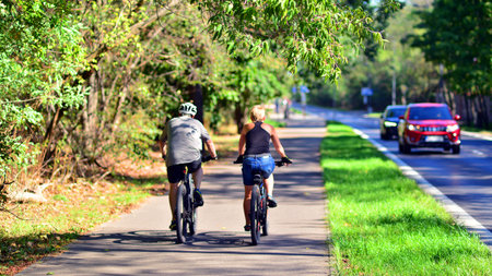Man and women at bicycle, in the middle of summer nature. Concept of a healthy lifestyle.の写真素材