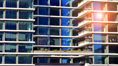 View of modern office building with many windows against clear sky. Glass facade wall.の写真素材