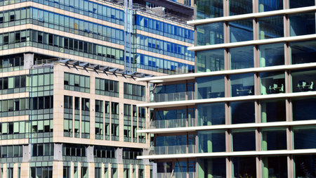 View of modern office building with many windows against clear sky. Glass facade wall.