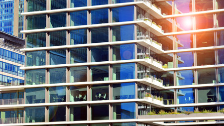 View of modern office building with many windows against clear sky. Glass facade wall.の写真素材