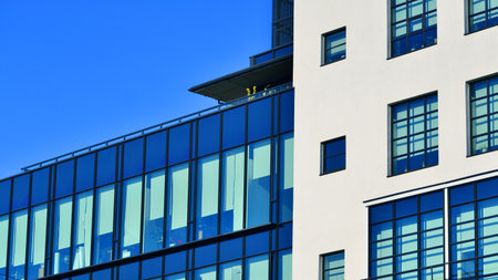 Office building in loft style. Facade of commercial office with windows. White walls of an...