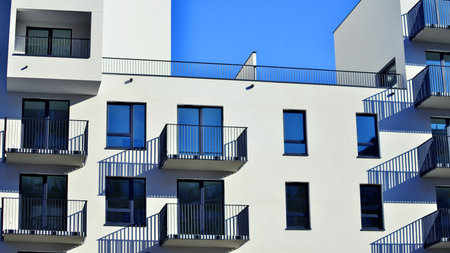 Modern luxury residential apartment. Modern apartment building on a sunny day. Apartment building with a blue sky. Facade of a modern apartment building.の写真素材