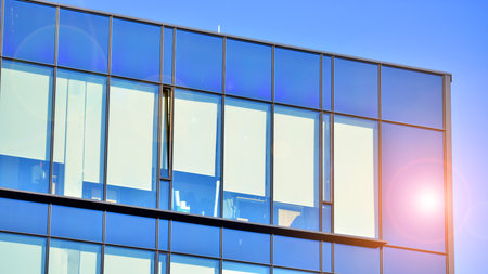 Office building in loft style. Facade of commercial office with windows. Glasses walls of an...