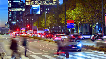 Warsaw, Poland. 4 November 2025. Blurred people cross a street at a crosswalk in center city in the...