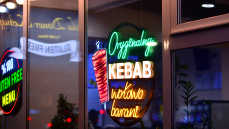 Warsaw, Poland. 4 November 2025. City life after dark. Company signboard "Original Kebab". Dense corporate development in city center at night. Lights street and buildingsのeditorial素材
