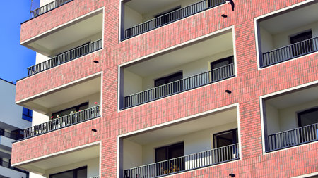 Modern luxury residential apartment. Modern apartment building on a sunny day. Apartment building with a blue sky. Facade of a modern apartment building.の写真素材