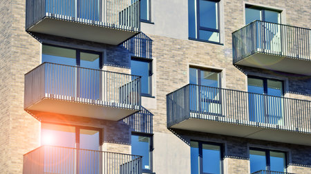 Modern luxury residential apartment. Modern apartment building on a sunny day. Apartment building with a blue sky. Facade of a modern apartment building.の写真素材