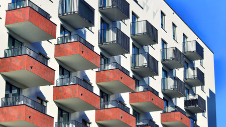 Modern luxury residential apartment. Modern apartment building on a sunny day. Apartment building with a blue sky. Facade of a modern apartment building.の写真素材