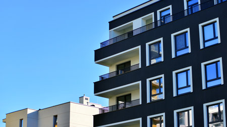 Modern luxury residential apartment. Modern apartment building on a sunny day. Apartment building with a blue sky. Facade of a modern apartment building.の写真素材