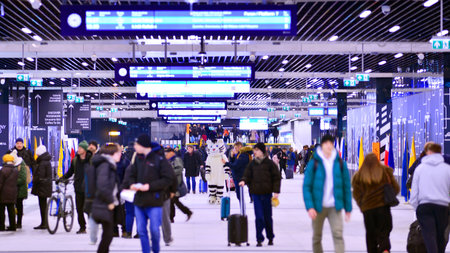 Warsaw, Poland. 28 November 2025. Commuters going through the underground passage hall at Warszawa Zachodnia train station. Ceiling mounted large artificial illumination.のeditorial素材