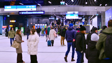 Warsaw, Poland. 28 November 2025. Commuters going through the underground passage hall at Warszawa...