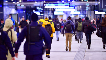 Warsaw, Poland. 28 November 2025. Commuters going through the underground passage hall at Warszawa...