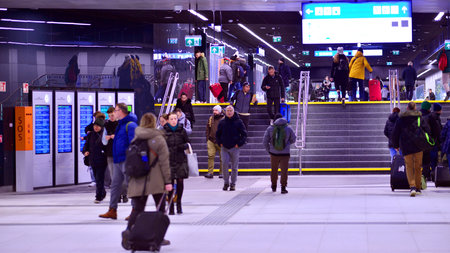 Warsaw, Poland. 28 November 2025. Commuters going through the underground passage hall at Warszawa...