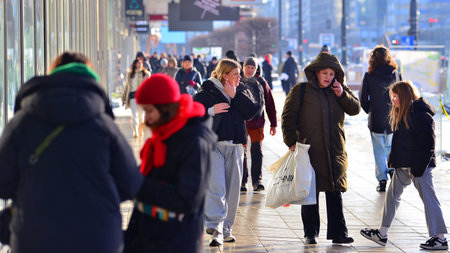 Warsaw, Poland. 5 January 2026. People walking on the street in the city on a winter cold day. Crowd of anonymous people walking on busy street. Urban street life.のeditorial素材