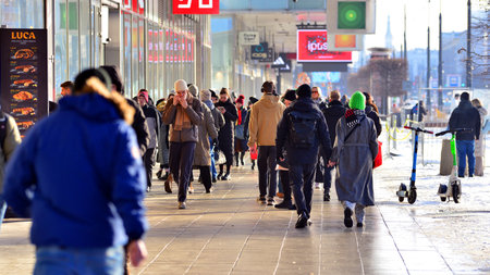 Warsaw, Poland. 5 January 2026. People walking on the street in the city on a winter cold day. Crowd of anonymous people walking on busy street. Urban street life.のeditorial素材