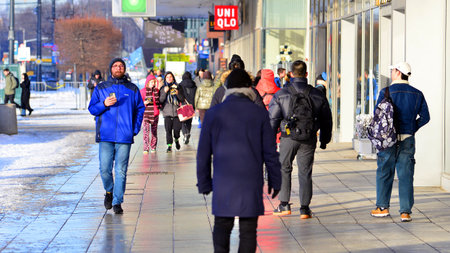 Warsaw, Poland. 5 January 2026. People walking on the street in the city on a winter cold day. Crowd of anonymous people walking on busy street. Urban street life.のeditorial素材