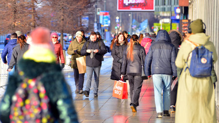 Warsaw, Poland. 5 January 2026. People walking on the street in the city on a winter cold day. Crowd of anonymous people walking on busy street. Urban street life.のeditorial素材