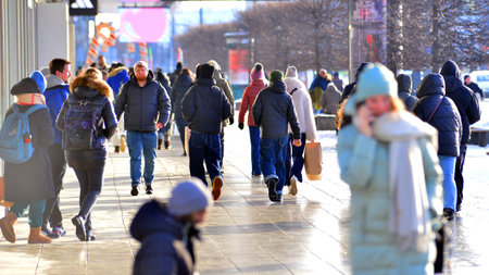 Warsaw, Poland. 5 January 2026. People walking on the street in the city on a winter cold day. Crowd of anonymous people walking on busy street. Urban street life.のeditorial素材