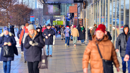 Warsaw, Poland. 5 January 2026. People walking on the street in the city on a winter cold day. Crowd of anonymous people walking on busy street. Urban street life.のeditorial素材