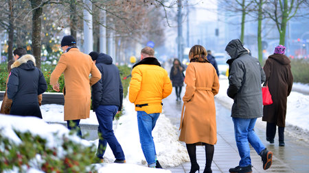 Warsaw, Poland. 15 January 2026. People walking on the street in the city on a winter cold day. Crowd of anonymous people walking on busy street. Urban street life.のeditorial素材