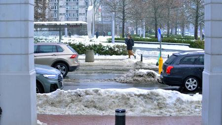 Warsaw, Poland. 15 January 2026. Downtown street traffic on road on winter day. View of a street in city center with traffic and buildings on a winter day.のeditorial素材