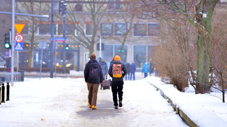 Warsaw, Poland. 15 January 2026. People walking on the street in the city on a winter cold day. Crowd of anonymous people walking on busy street. Urban street life.のeditorial素材