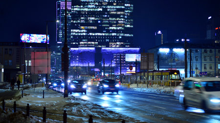 Warsaw, Poland. January 21, 2026. City life after dark. Traffic with cars passing on the street in center city in the night. Lights street and buildings towering around them.のeditorial素材