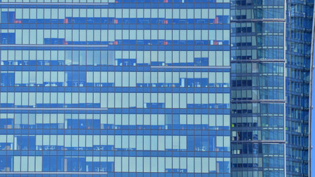 Modern office building with glass facade background. Transparent glass wall of office building.