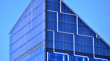 The top of a glass skyscraper. Tall glass skyscraper in the city center.