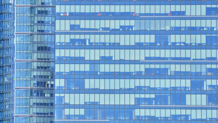 Modern office building with glass facade background. Transparent glass wall of office building.