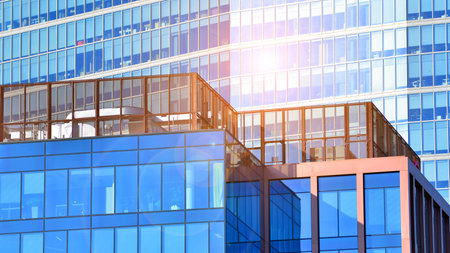 Modern glass office buildings. In the foreground is an office building with air conditioning on the...