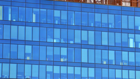Modern office building with glass facade background. Transparent glass wall of office building.