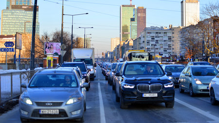Warsaw, Poland. February 3, 2026. Street traffic on road on winter day. View of a street in city...