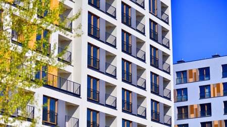 European residential architecture harmonizing with nature. Eco-friendly living in city with greens. Eco apartment building saving energy and fresh air concept.