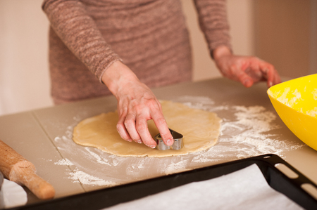Woman making cookies in kitchen closeup. Cooking. の写真素材