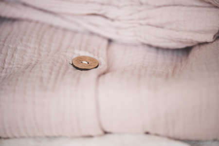 Stack of folded textile in room. Spring female clothes. Fashionable.