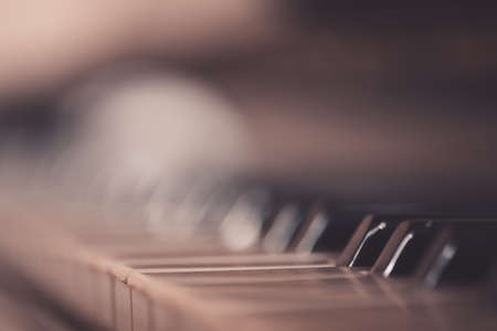 Old vintage piano closeup with focus on keys.の写真素材