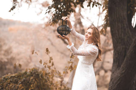Beautiful lady girl 22-24 year old wearing vintage white dress outdoors. Wedding day. 20s. Celebrationの写真素材
