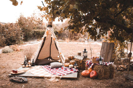 Autumn decorations with wigwam, pumpkins and hay.の写真素材