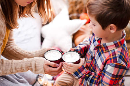 Mother drinking tea with kid son outdoors. Motherhood. Maternity.の写真素材