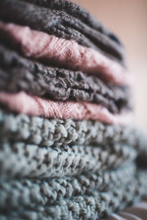 Stack of knitte clothes closeup. Winter season. Selective focus.の写真素材