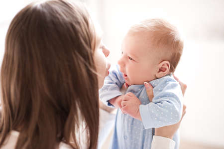 Mother holding baby boy 2-3 months old closeup. Looking at each other. Motherhood. Maternity.の写真素材