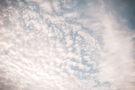 Cloudy blue sky with spindrift clouds outdoors. Nature background and texture.