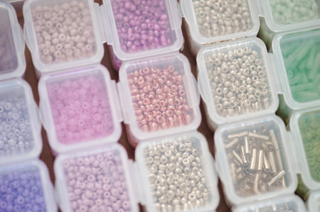 Colorful beads in plastic box organizer closeup. Handmade and hobby materials.