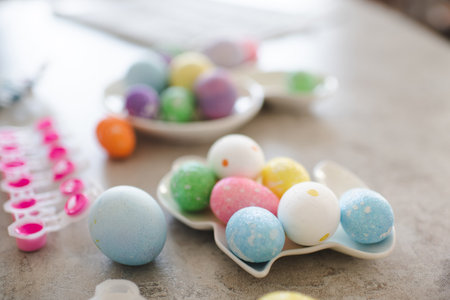 Colorful Easter eggs in rabbit shape plate on kitchen table closeup. holiday celebration.の写真素材