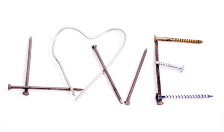 Sign Love made by metal nails isolated on white backgroundの写真素材