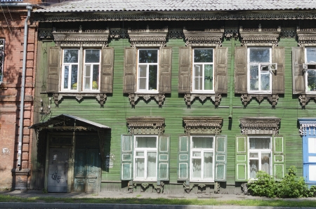 Old two-story wooden house with shutters and carving frames  Irkutskの写真素材