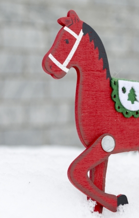 Red wooden horse on the snowの写真素材