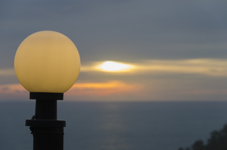 Round lantern at sunset on the sea