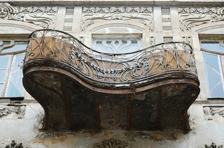 Facade sculpture on an old apartment building with wrought balconies in Tbilisi Georgiaのeditorial素材